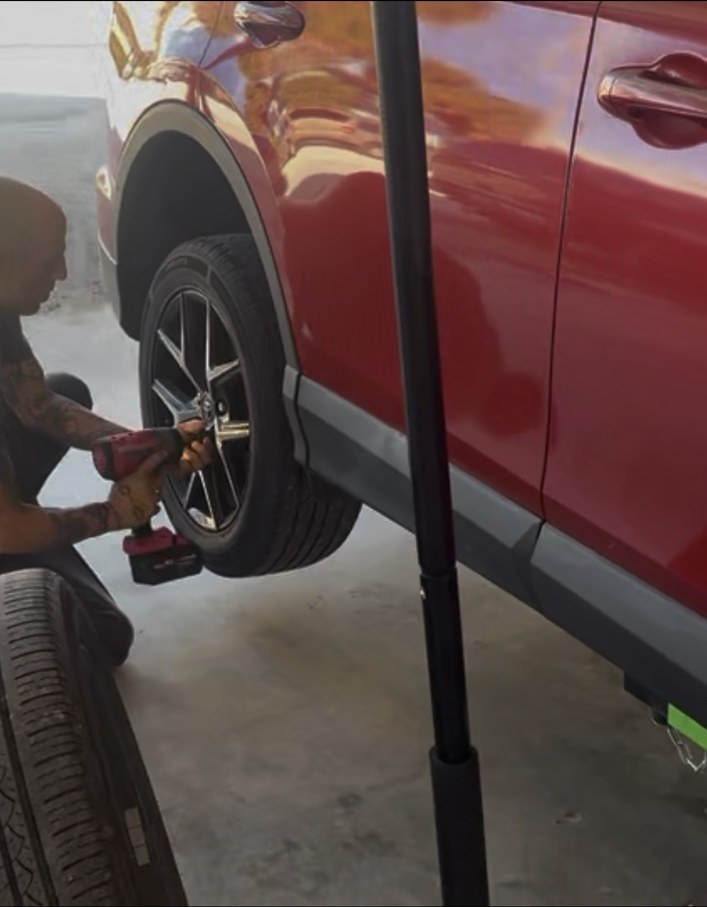 Keys Quick Lube technician working on a vehicle wheel